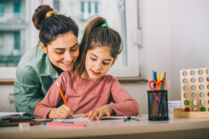 mother helping her daughter while studying