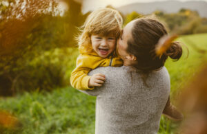 toddler playing with mother