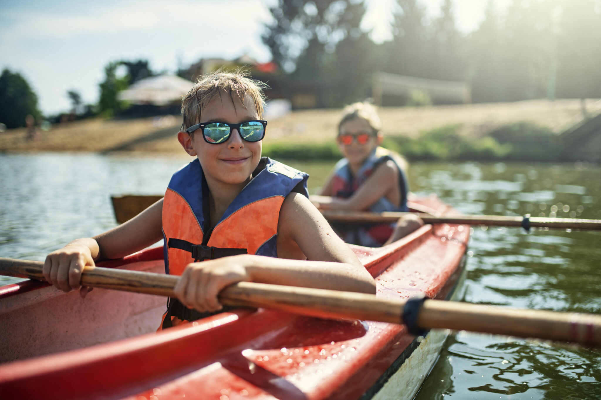 two boys enjoying kayaking on lake