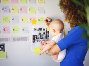 working mother balancing baby and design work