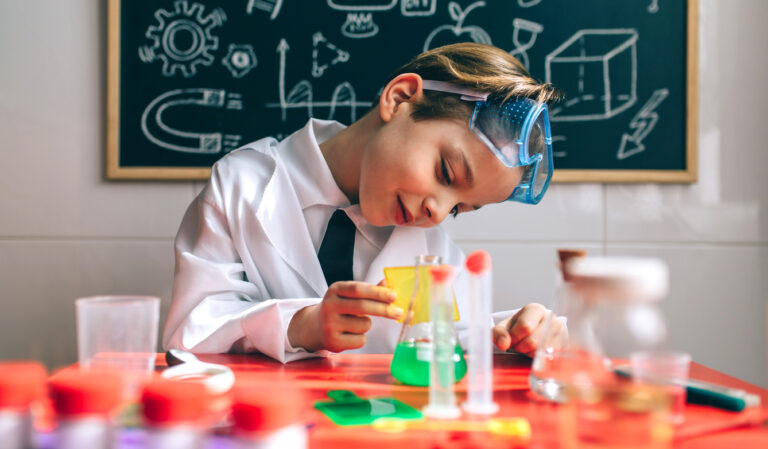 boy playing with chemistry game