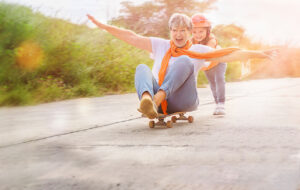 senior and child on skateboard