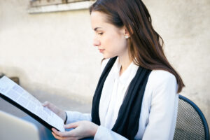 cheerful businesswoman reading documents