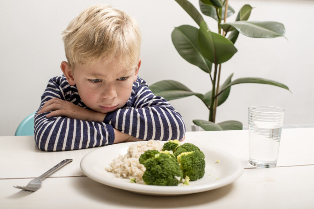 boy does not want to eat his veggies